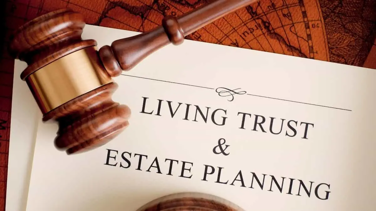 A document titled Living Trust and Estate Planning beneath a wooden gavel, with an antique map in the background