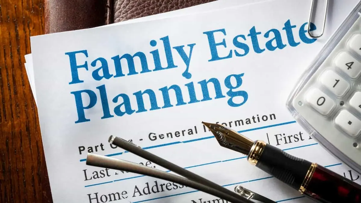 A Family Estate Planning form with a fountain pen and a calculator on a desk